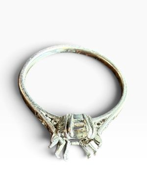 an image of a silver ring with a green stone in it