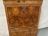 an old wooden chest of drawers with a marble top