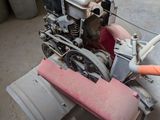 a small engine sitting on the floor in a garage