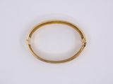 a close up of a gold ring on a white surface