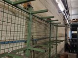 a large green cage in the middle of a room