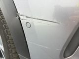 a close up of a car door handle with a hole in it