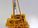 a yellow bulldozer that is sitting on a white surface