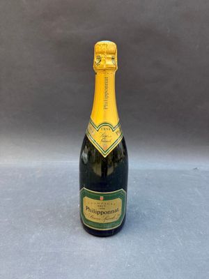 a bottle of champagne on a table with a gray background