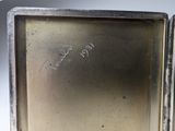 silver plated box with writing on the inside of it