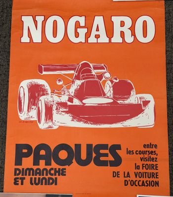 an orange poster with a picture of a racing car on it