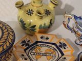 many different types of pottery sitting on a table