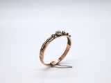 a rose gold ring with black diamonds on a chain