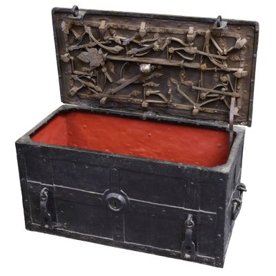 a black chest with a red lining inside of it