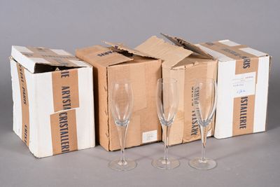 three empty wine glasses sitting next to a box of empty wine glasses
