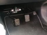 two pedals that are sitting on the floor of a car