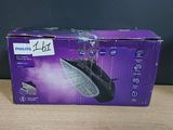 the box is open on a table with a black and purple package on it