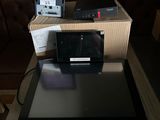 a tablet computer sitting on top of a table next to a box