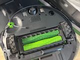 a robot that is sitting on the floor next to a laptop
