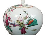 a white vase with a painting on it on the table