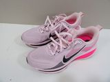 pink nike running shoes with pink laces are on a white surface