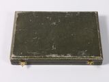 an old suitcase sitting on top of a white surface