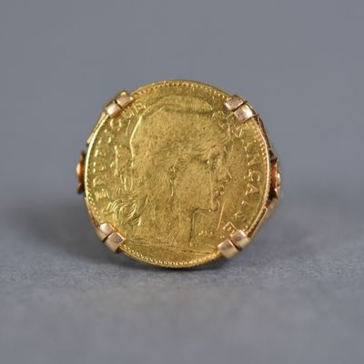 an image of a gold coin ring with a woman ' s face on it