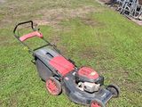 a lawn mower sitting on the grass in the yard