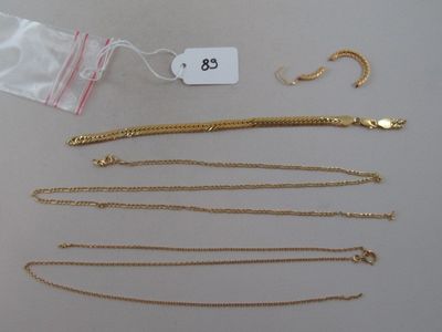 a lot of gold necklaces and bracelets laid out on a table