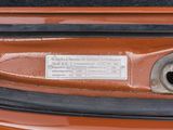 a close up of a car ' s front bumper with a tag on it
