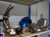 many different types of exhaust pipes on a shelf
