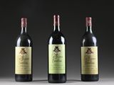 three bottles of wine are lined up on a table