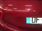 a close up of a red car with a license plate on it