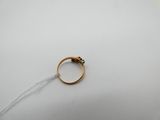 a close up of a gold ring on a white surface