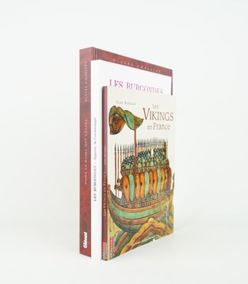 two books sitting on top of each other on a white surface
