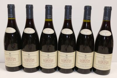 six bouteilles de vin sont alignées sur une table
