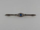 a silver and blue stone tie bar on a white background
