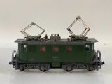 a green train on a white surface with a white background