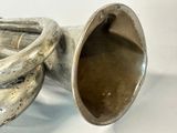 a silver trumpet that is sitting on a table