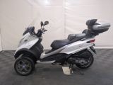 a picture of a motor scooter parked on a checkered floor