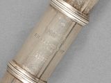 a close up of a metal object on a gray surface