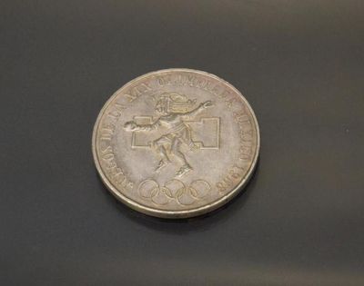 a silver coin with a picture of a man on it