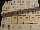 a lot of drawings on a table with a shadow on it