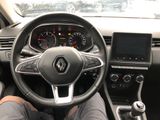 the steering wheel of a car with a person sitting in the driver ' s seat