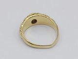 a close up of a gold ring on a white surface