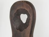 wooden sculpture of a heart shaped hole in the back of a wooden chair