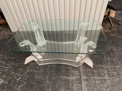 a glass table with a glass top on a tile floor