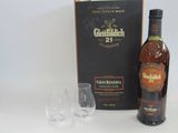 a bottle of glenfiddich 21 years old next to two empty wine glasses