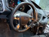 a car dashboard with a steering wheel and a dash board