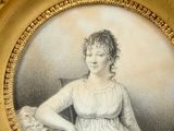 portrait of a woman in a white dress sitting at a table