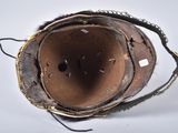 a close up view of a leather boot with a hole in it