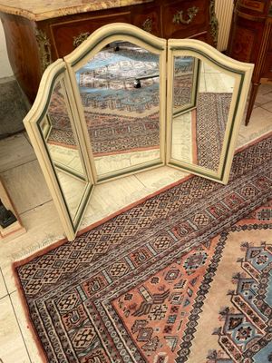 a mirror that is sitting on the floor next to a rug