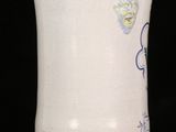 a white vase with blue designs on it on a black background