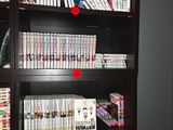 a book shelf with many dvds on it in a room