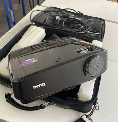 a camera sitting on top of a suitcase on a table